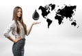 Beautiful businesswoman standing with big oil drop above her open palm on white background