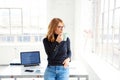 Beautiful businesswoman standing in the office while drinking her coffee Royalty Free Stock Photo