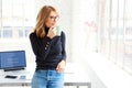 Beautiful businesswoman standing in the office while drinking her coffee Royalty Free Stock Photo