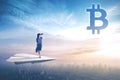 Beautiful businesswoman looking at bitcoin symbol