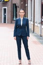 beautiful businesswoman standing on street and looking Royalty Free Stock Photo