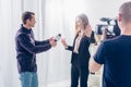 Beautiful businesswoman in suit rejecting giving interview to journalist and showing stop sing to cameraman Royalty Free Stock Photo
