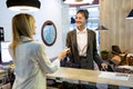 Beautiful businesswoman takes room key card and doing check-in at the hotel reception Royalty Free Stock Photo