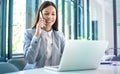 Beautiful businesswoman talking on mobile phone and using laptop in office Royalty Free Stock Photo