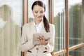 Beautiful businesswoman using digital tablet against office building Royalty Free Stock Photo