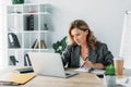 beautiful businesswoman using laptop and writing something to notebook Royalty Free Stock Photo