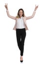Beautiful businesswoman walks and celebrates with hands in the air