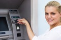 Beautiful businesswoman withdrawing money from credit card