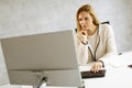 Beautiful businesswoman working on laptop in bright modern office Royalty Free Stock Photo