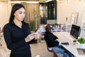 Beautiful young businesswoman writing a text on smart phone. Smiling woman feeling happy on reading a message on smartphone. Royalty Free Stock Photo