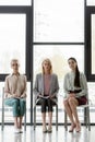 beautiful businesswomen sitting on chairs during meeting