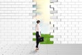 Beautiful businesswomen watching dilapidated brick wall