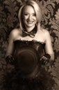 beautiful cabaret woman posing with tophat against retro wallpapers