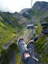 Beautiful cable car ride, sneakers on the background of a mountain landscape, first-person photo.