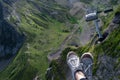 Beautiful cable car ride, sneakers on the background of a mountain landscape, first-person photo.