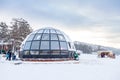 A beautiful cafe in the form of a hemisphere or a dome of glass and windows in winter with snow in the Altai mountains in the