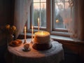 Beautiful cake, candles and tea set on table by the window at sunset Royalty Free Stock Photo