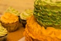 Beautiful cake and chocolate muffins on a wooden table