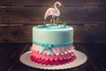 Beautiful cake, decorated with a figure of pink flamingos in the pond. Concept of the Original design of desserts