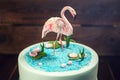 Beautiful cake, decorated with a figure of pink flamingos in the pond. Concept of the Original design of desserts