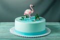 Beautiful cake, decorated with a figure of pink flamingos in the pond. Concept of the Original design of desserts