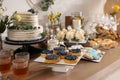 Beautiful cake and other treats on table in room. Baby shower party Royalty Free Stock Photo