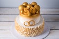 Beautiful cake for the 50th anniversary of the wedding decorated with gold balls and rings. Concept of festive desserts