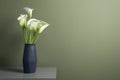 Beautiful calla lily flowers in vase on grey table near olive wall. Space for text