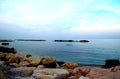 Calm Adriatic sea surrounded by massive rocks under the light blue sky in Pedaso