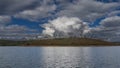 A beautiful calm blue lake. Trees grow on the hilly shores. Royalty Free Stock Photo