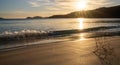 Beautiful and calm golden sand beach with small waves lapping at the shore and driftwood coral at sunset Royalty Free Stock Photo