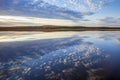 Beautiful calm lake with cloudscape reflecting and hills with trees in autumn color in northern Minnesota Royalty Free Stock Photo