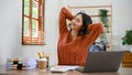 Beautiful calm Asian businesswoman relaxing at her desk during break Royalty Free Stock Photo