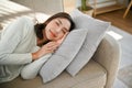 Beautiful, calm and peaceful Asian woman napping or sleeping on couch in her living room Royalty Free Stock Photo