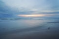 A beautiful, calm and quiet view of the beach and sunset sky over the horizon with copy space. A peaceful and scenic Royalty Free Stock Photo