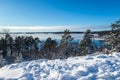 Beautiful calm and tranquil winter landscape mountain view with snowy tree and lake with blue sky horizon. Royalty Free Stock Photo