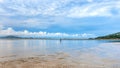 Beautiful calmness seascape with fisherman in cloudy blue sky