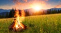 beautiful campfire in the middle of a green meadow and a beautiful sunset in high definition