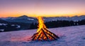 beautiful campfire in the middle of a mountain in winter with a beautiful sunset