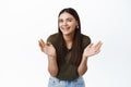 Beautiful candid woman laughing and clapping hands, looking happy at camera with cheerful natural smile, standing