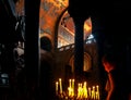 Unidentified girl with lit candles in Basilica in Venice