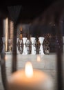 Beautiful candle light wax candles lit in stunning wedding ceremony venue