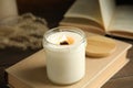 Beautiful candle with wooden wick on book