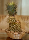 Beautiful cane basket with fresh raw cut pineapple on the glass table