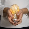 Decorative light bulb in the hands of a child Royalty Free Stock Photo