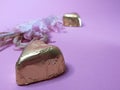 Pink flowers and chocolate candies on a pink background Royalty Free Stock Photo