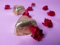 Red roses and chocolate candies on a pink background Royalty Free Stock Photo