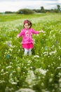 Beautiful carefree girl playing outdoors in field Royalty Free Stock Photo