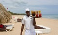 Beautiful Caribbean beach and local waiter