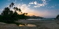 Beautiful Caribbean beach with palm trees and sunset in Tayrona National Park